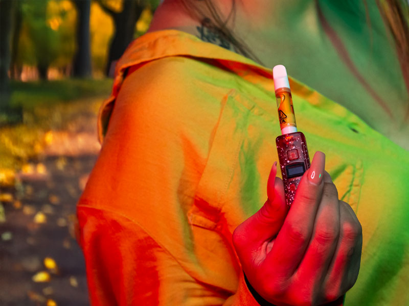 Women in jacket holding the Wulf XRay KODO Pro outside in fall weather